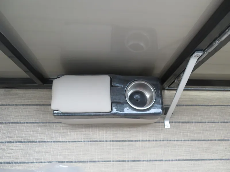Slide: The Image of 2025 Avalon LSZ Quad Lounger cup holder and armrest on a boat deck. - 48
