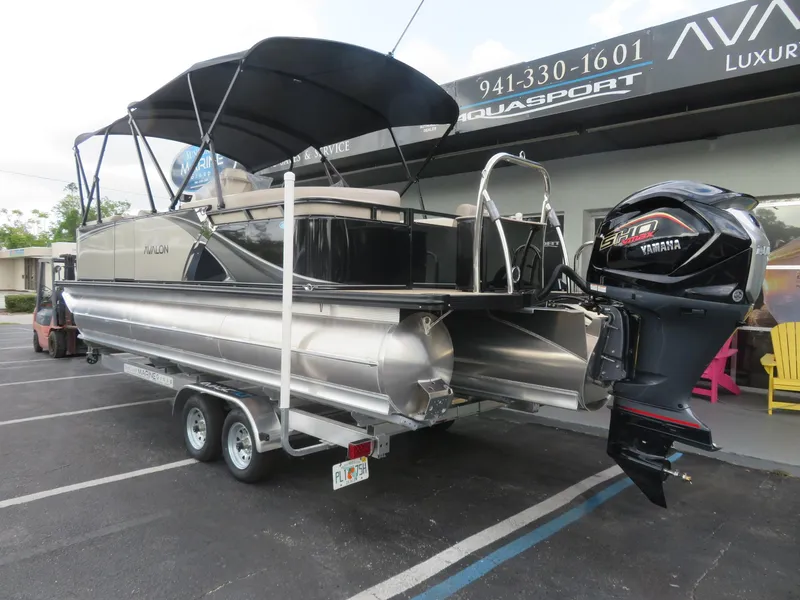 Slide: The Image of 2025 Avalon LSZ Quad Lounger pontoon boat with Yamaha engine on trailer. - 7