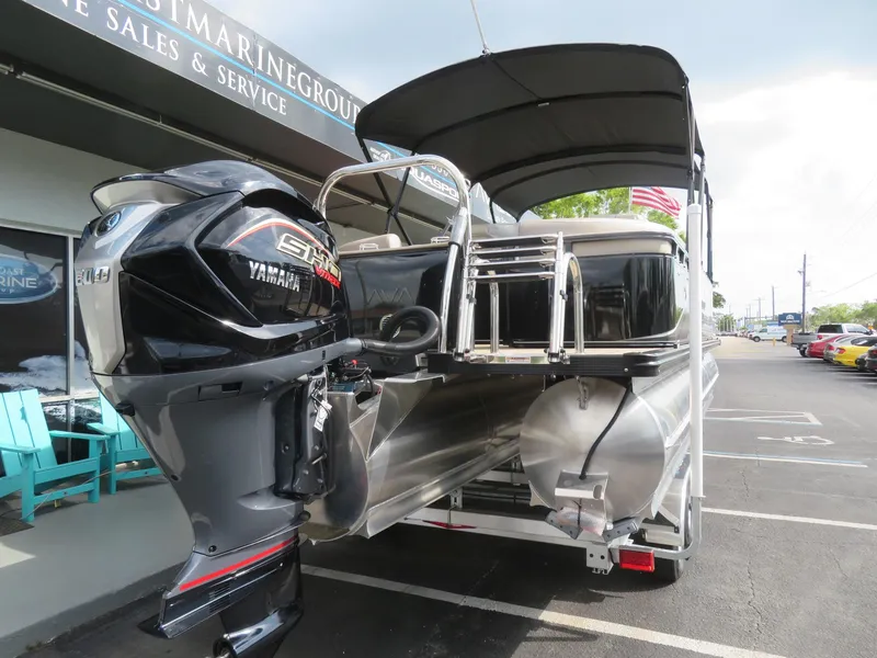 Slide: The Image of 2025 Avalon LSZ Quad Lounger pontoon boat with Yamaha engine at a dealership. - 9