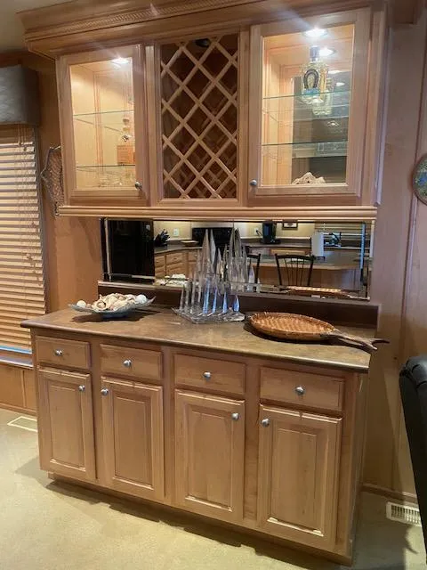 Slide: The Image of Wooden cabinetry with glass doors and wine rack in 2007 Sharpe 18 x 84 houseboat. - 10