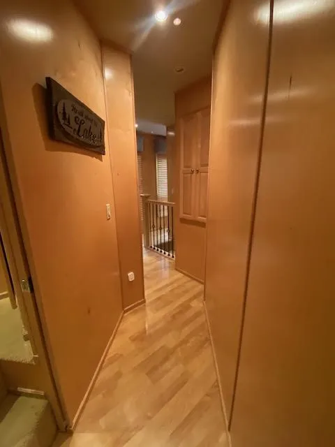 Slide: The Image of Narrow hallway in a 2007 Sharpe 18 x 84 houseboat with wooden walls and flooring. - 11