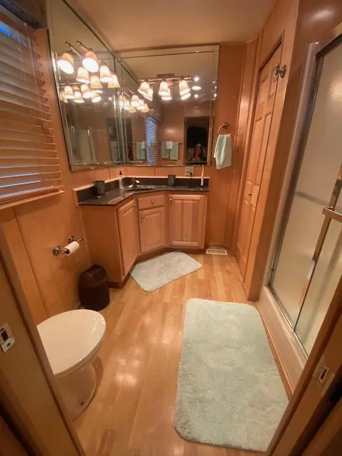 Slide: The Image of Luxurious bathroom in a 2007 Sharpe 18 x 84 houseboat with wood accents and modern fixtures. - 14