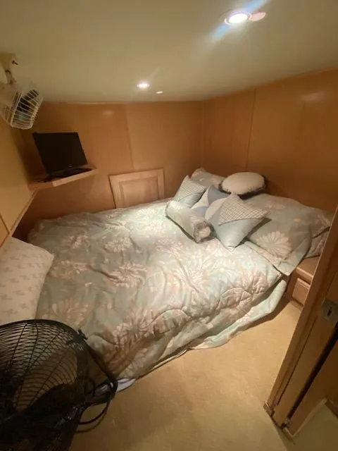 Slide: The Image of Cozy bedroom in 2007 Sharpe 18 x 84 houseboat with bed, pillows, and fan. - 16