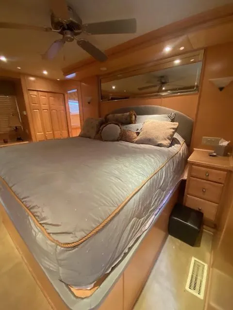 Slide: The Image of Luxurious bedroom interior of 2007 Sharpe 18 x 84 houseboat with cozy bedding and wooden accents. - 24