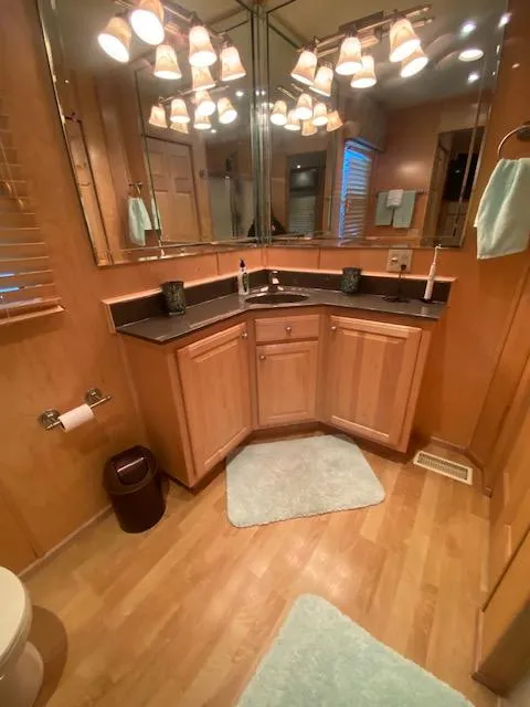 Slide: The Image of Luxurious bathroom in 2007 Sharpe 18 x 84 houseboat with wooden cabinetry and elegant lighting. - 25