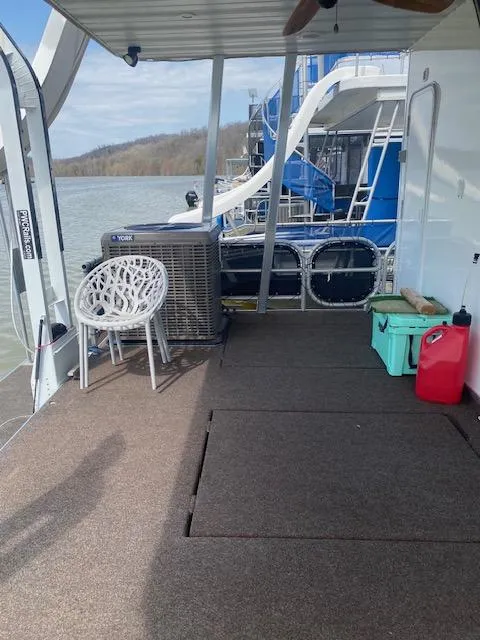 Slide: The Image of 2007 Sharpe 18 x 84 houseboat deck with chairs, air conditioner, and scenic water view. - 26