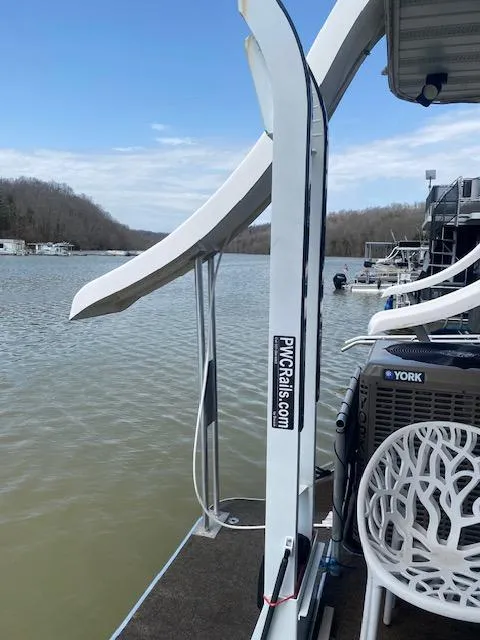 Slide: The Image of 2007 Sharpe 18 x 84 houseboat with slide, docked on a calm lake. - 27
