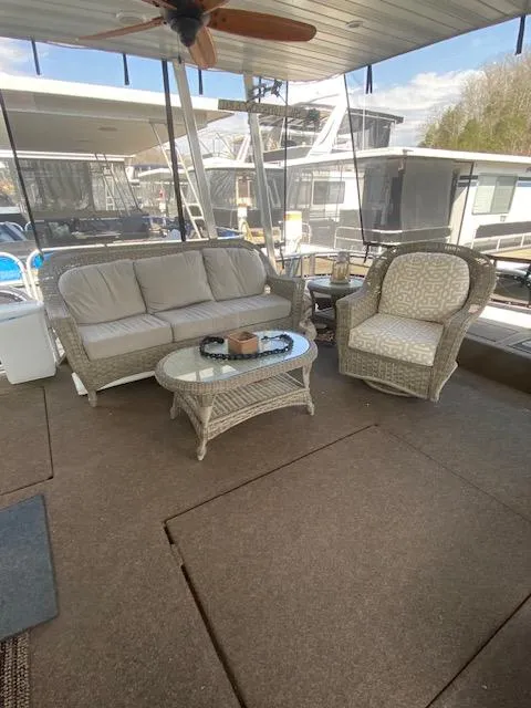 Slide: The Image of 2007 Sharpe 18 x 84 Houseboat deck with wicker furniture and ceiling fan. - 3