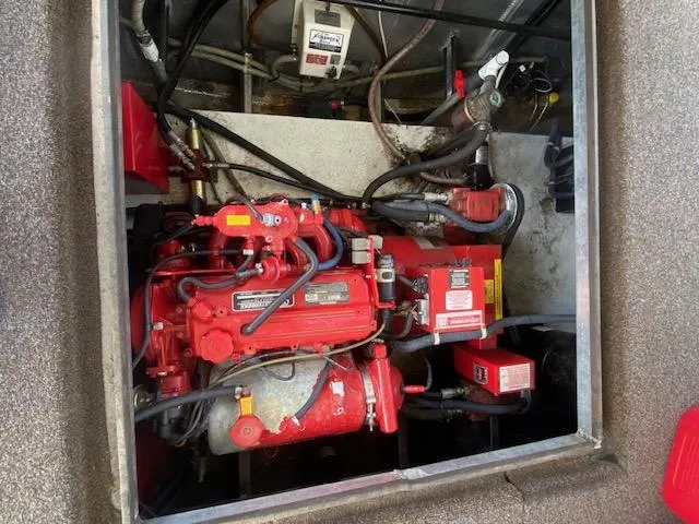 Slide: The Image of Engine compartment of a 2007 Sharpe 18 x 84 Houseboat, featuring a red engine. - 31
