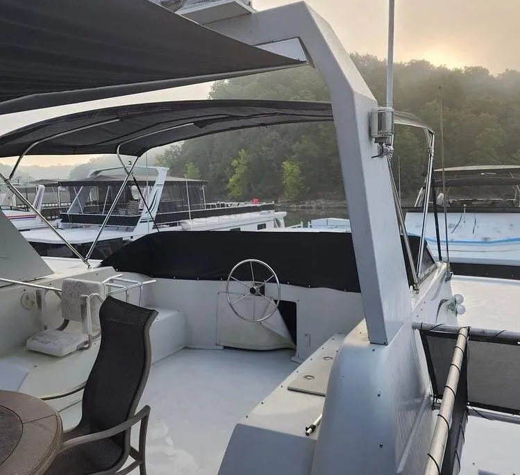 Slide: The Image of 2007 Sharpe 18 x 84 Houseboat with canopy, docked near lush greenery. - 32