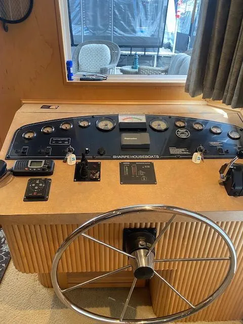 Slide: The Image of 2007 Sharpe 18 x 84 Houseboat helm with steering wheel and control panel. - 4