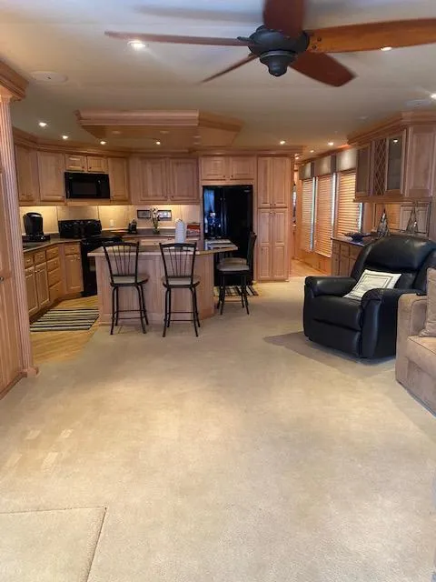 Slide: The Image of Interior of 2007 Sharpe 18 x 84 houseboat with modern kitchen and cozy living area. - 5