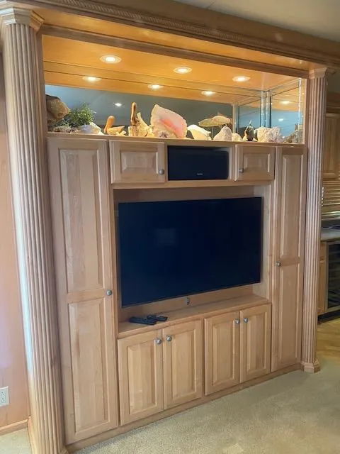 Slide: The Image of Wooden entertainment center with TV, decorative shells, and built-in lighting on a 2007 Sharpe houseboat. - 7