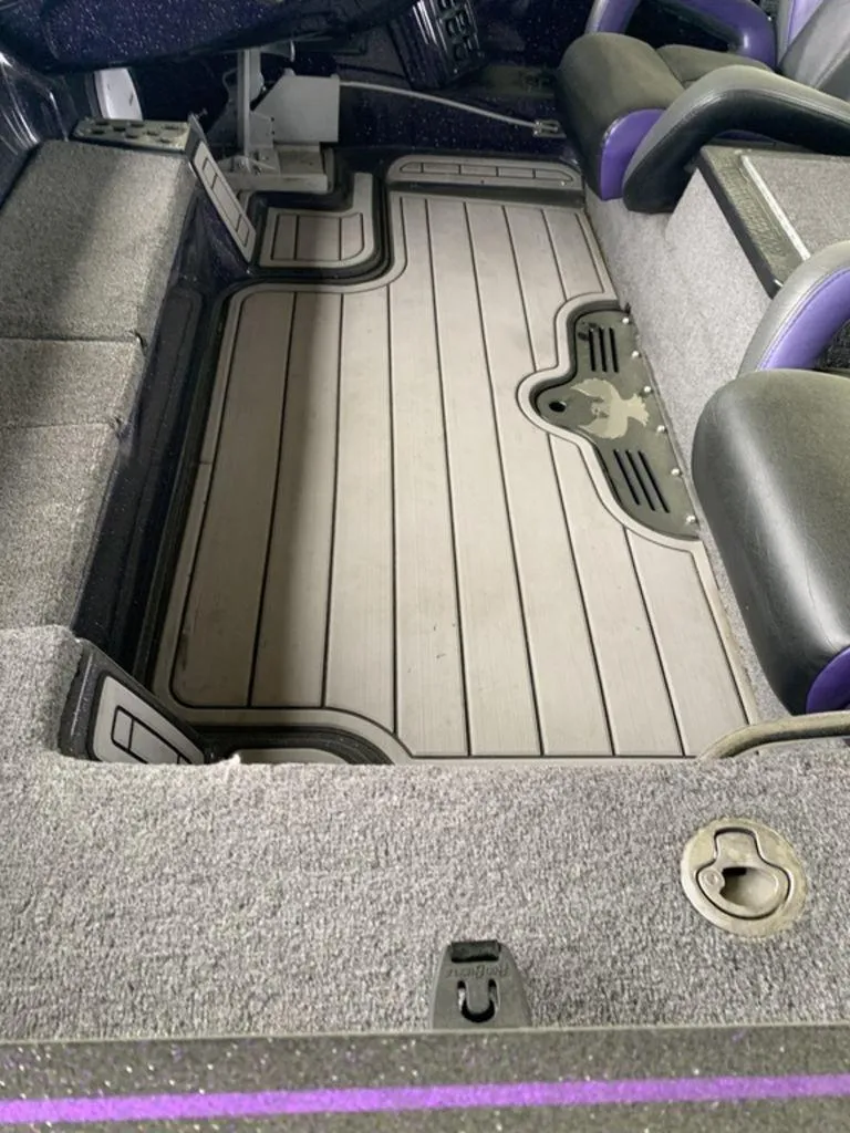 Slide: The Image of 2021 Phoenix Bass Boats 20 PHX interior with gray flooring and black seats. - 9