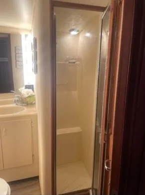 Slide: The Image of 1989 Viking 41 Convertible yacht bathroom with shower and vanity. - 13