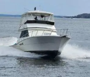 Slide: The Image of 1989 Viking 41 Convertible yacht cruising on open water. - 4