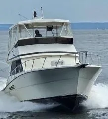 Slide: The Image of 1989 Viking 41 Convertible yacht cruising on open water. - 5