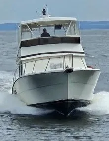 Slide: The Image of 1989 Viking 41 Convertible yacht cruising on open water. - 6