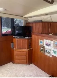 Slide: The Image of 1989 Viking 41 Convertible interior with wood paneling, TV, and framed pictures. - 8