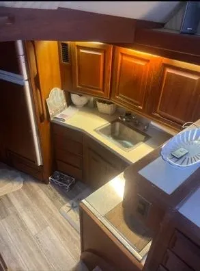 Slide: The Image of 1989 Viking 41 Convertible yacht kitchen with wooden cabinets and modern appliances. - 9