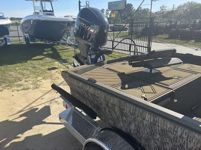 Slide: The Image of 2025 Thor LH1900 DLX Side Console boat with Baystar steering, parked outdoors. - 12