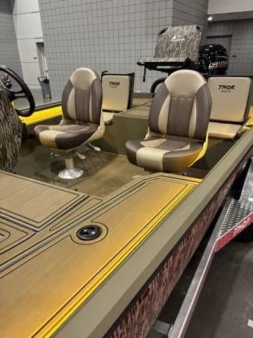 Slide: The Image of 2025 Thor LH1900 DLX Side Console boat with Baystar steering, featuring stylish seating. - 13