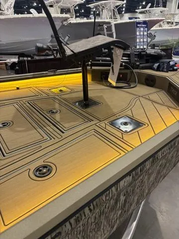 Slide: The Image of 2025 Thor LH1900 DLX Side Console boat with Baystar steering, featuring illuminated deck and storage compartments. - 19