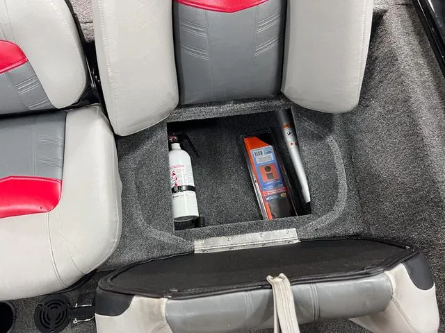 Slide: The Image of 2017 Tracker Pro Team™ 175 TXW boat storage compartment with fire extinguisher and tools. - 11
