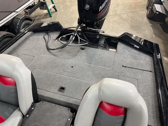 Slide: The Image of 2017 Tracker Pro Team™ 175 TXW boat interior with trailer, featuring seating and motor. - 5