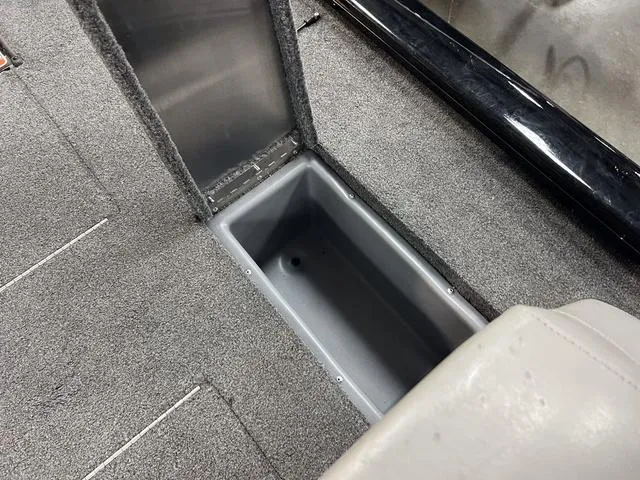 Slide: The Image of 2017 Tracker Pro Team™ 175 TXW boat storage compartment, gray interior, open lid. - 8