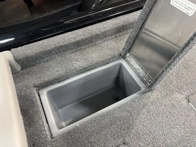 Slide: The Image of 2017 Tracker Pro Team™ 175 TXW storage compartment with open lid, showcasing interior space. - 9