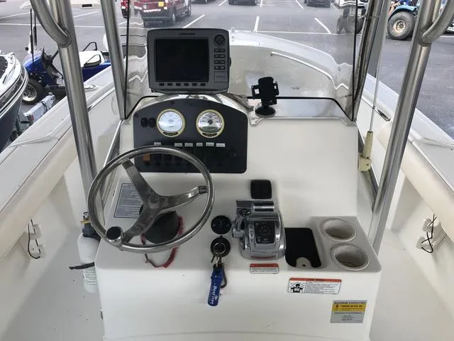 Slide: The Image of 2009 Mako 204 Center Console boat interior, featuring spacious seating and storage compartments. - 12