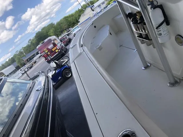 Slide: The Image of 2009 Mako 204 Center Console boat on trailer under a canopy. - 15
