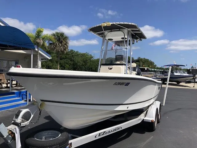 Slide: The Image of 2009 Mako 204 Center Console boat on trailer, parked outdoors under clear sky. - 17