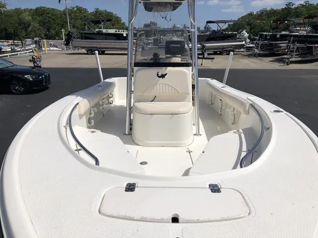 Slide: The Image of 2009 Mako 204 Center Console boat with spacious deck and seating, docked outdoors. - 18
