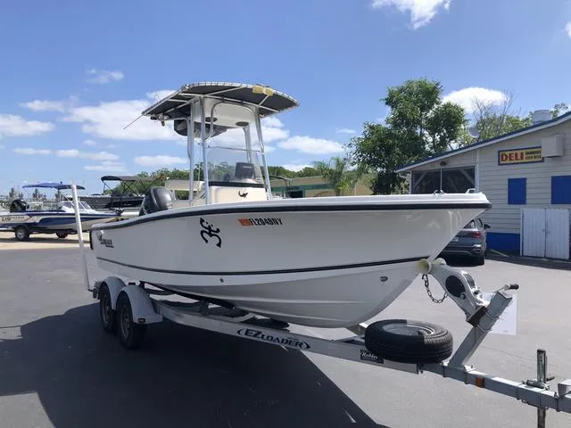 Slide: The Image of 2009 Mako 204 Center Console boat on trailer, parked outdoors under clear sky. - 20