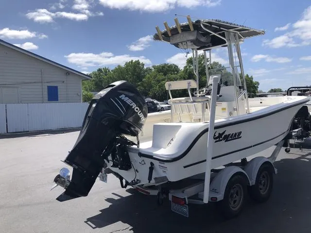 Slide: The Image of 2009 Mako 204 Center Console boat with Mercury outboard motor on trailer. - 21