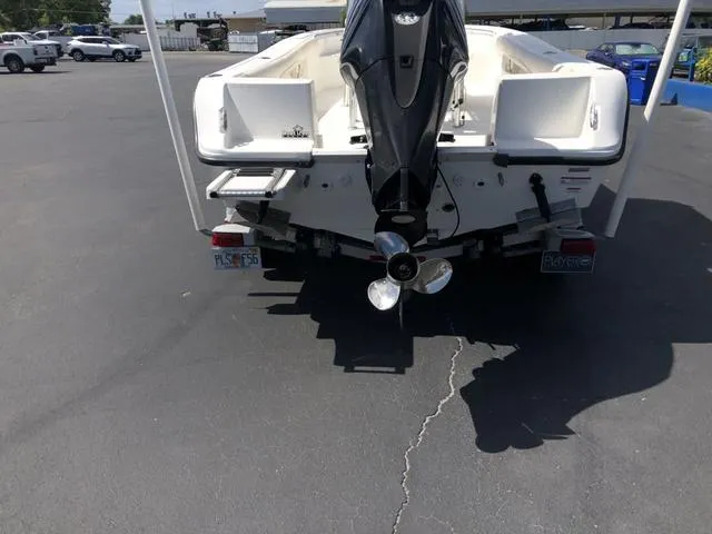 Slide: The Image of 2009 Mako 204 Center Console boat, rear view with outboard motor and propeller. - 23