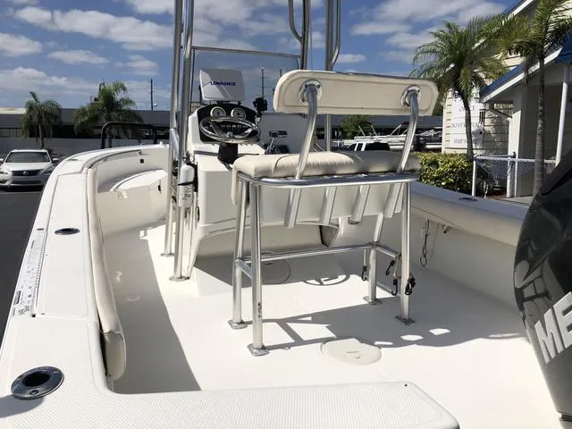 Slide: The Image of 2009 Mako 204 Center Console boat with seating, steering wheel, and clear skies. - 24