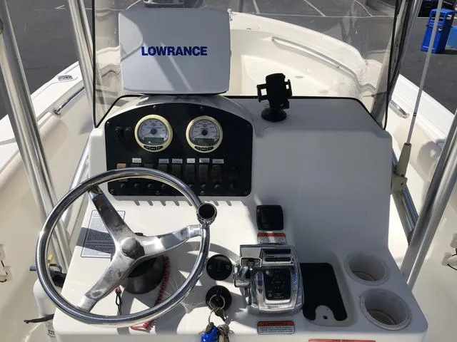 Slide: The Image of Center console of 2009 Mako 204 boat with steering wheel and Lowrance navigation system. - 25