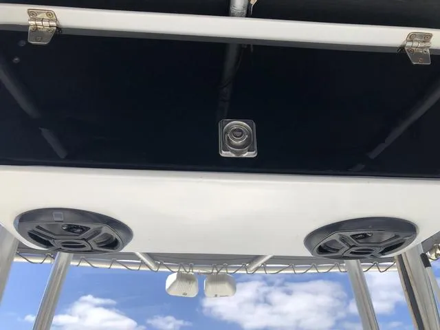 Slide: The Image of Speakers and camera on a 2009 Mako 204 Center Console boat, under a clear blue sky. - 26