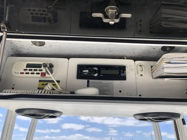 Slide: The Image of 2009 Mako 204 Center Console dashboard with radio and storage compartments. - 27