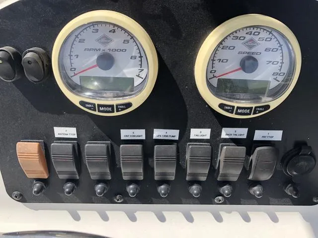 Slide: The Image of Control panel of a 2009 Mako 204 Center Console boat with gauges and switches. - 28
