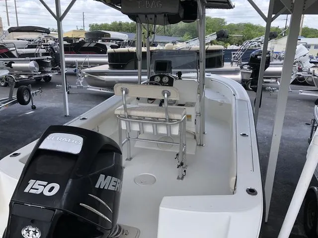 Slide: The Image of 2009 Mako 204 Center Console boat on EZ Loader trailer under a canopy. - 3