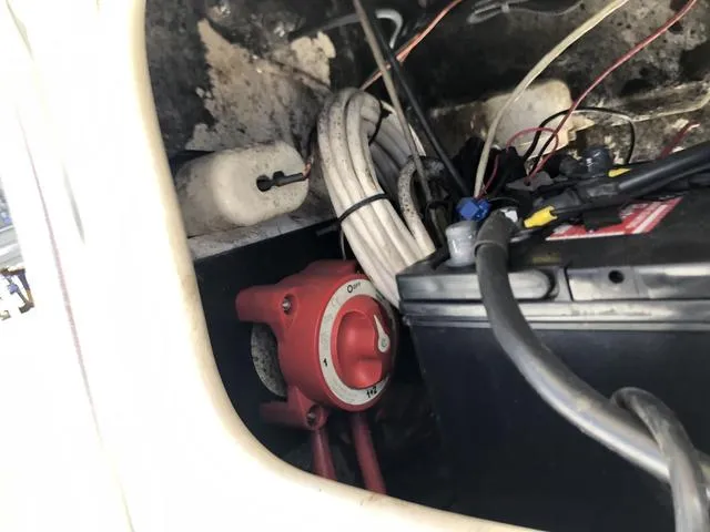 Slide: The Image of 2009 Mako 204 Center Console boat battery compartment with wiring and switch. - 31