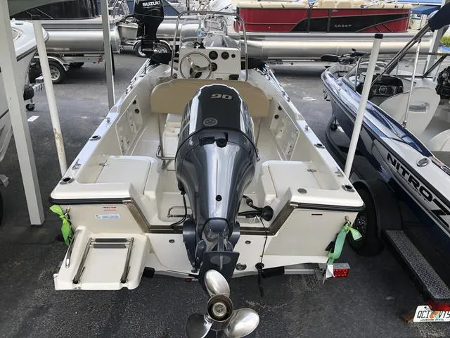 Slide: The Image of 2009 Mako 204 Center Console boat on EZ Loader trailer, parked under shelter. - 5