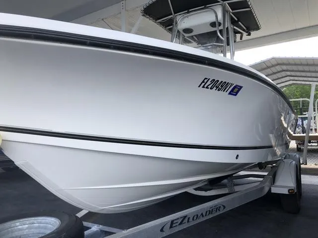 Slide: The Image of 2009 Mako 204 Center Console boat, white interior, docked in a marina. - 6