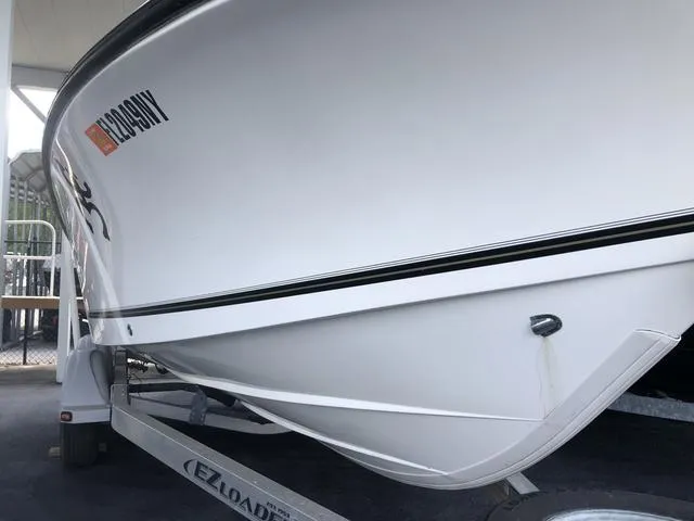 Slide: The Image of 2009 Mako 204 Center Console boat stern with motor and step ladder. - 8