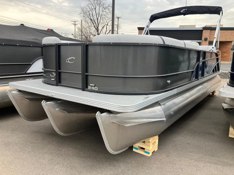 Slide: The Image of 2024 Crest 240 SLSC Classic LX pontoon boat in a showroom setting. - 0