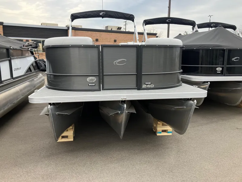 Slide: The Image of 2024 Crest 240 SLSC Classic LX pontoon boat displayed outdoors. - 1